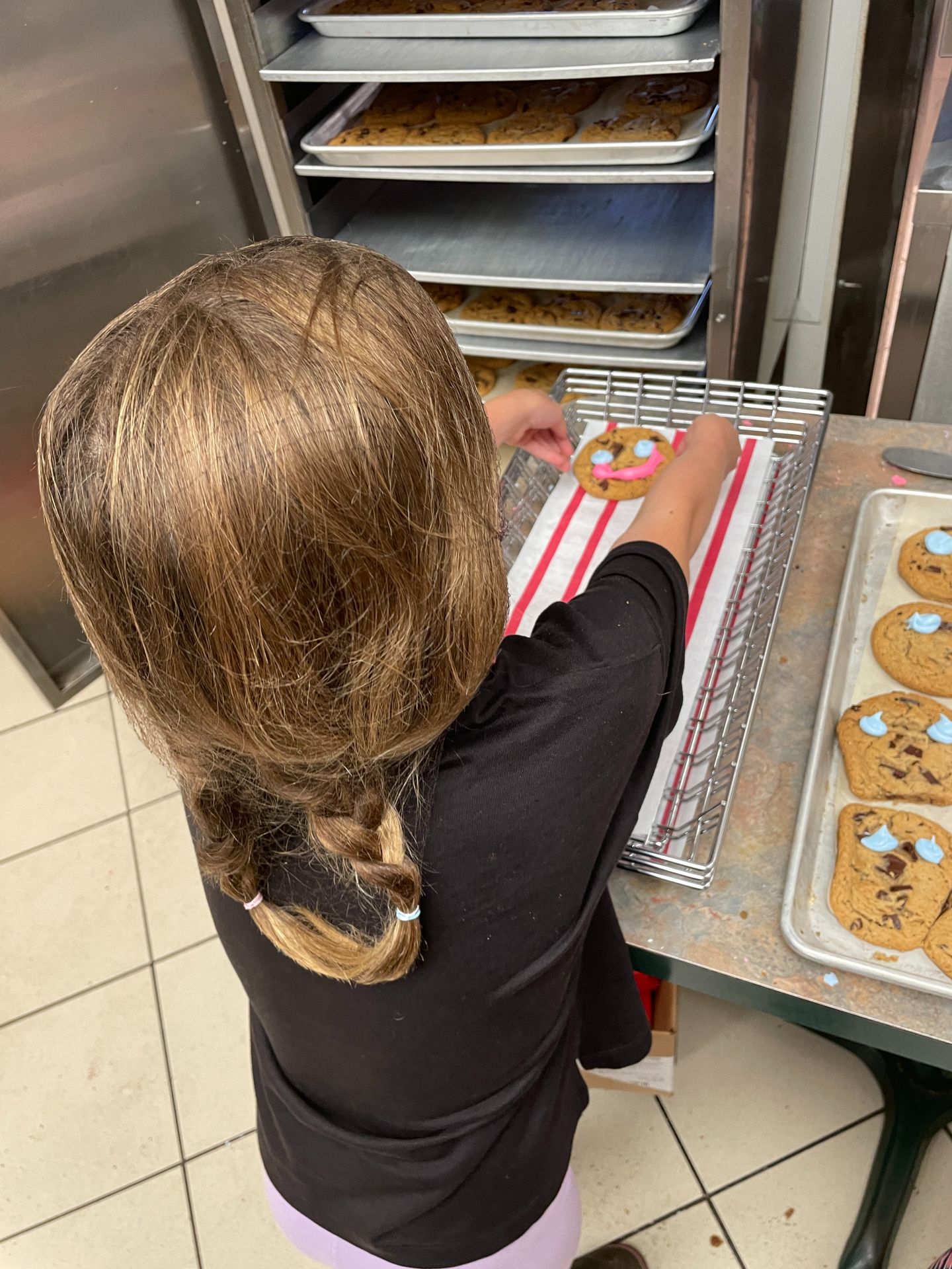 Callie putting cookies on tray