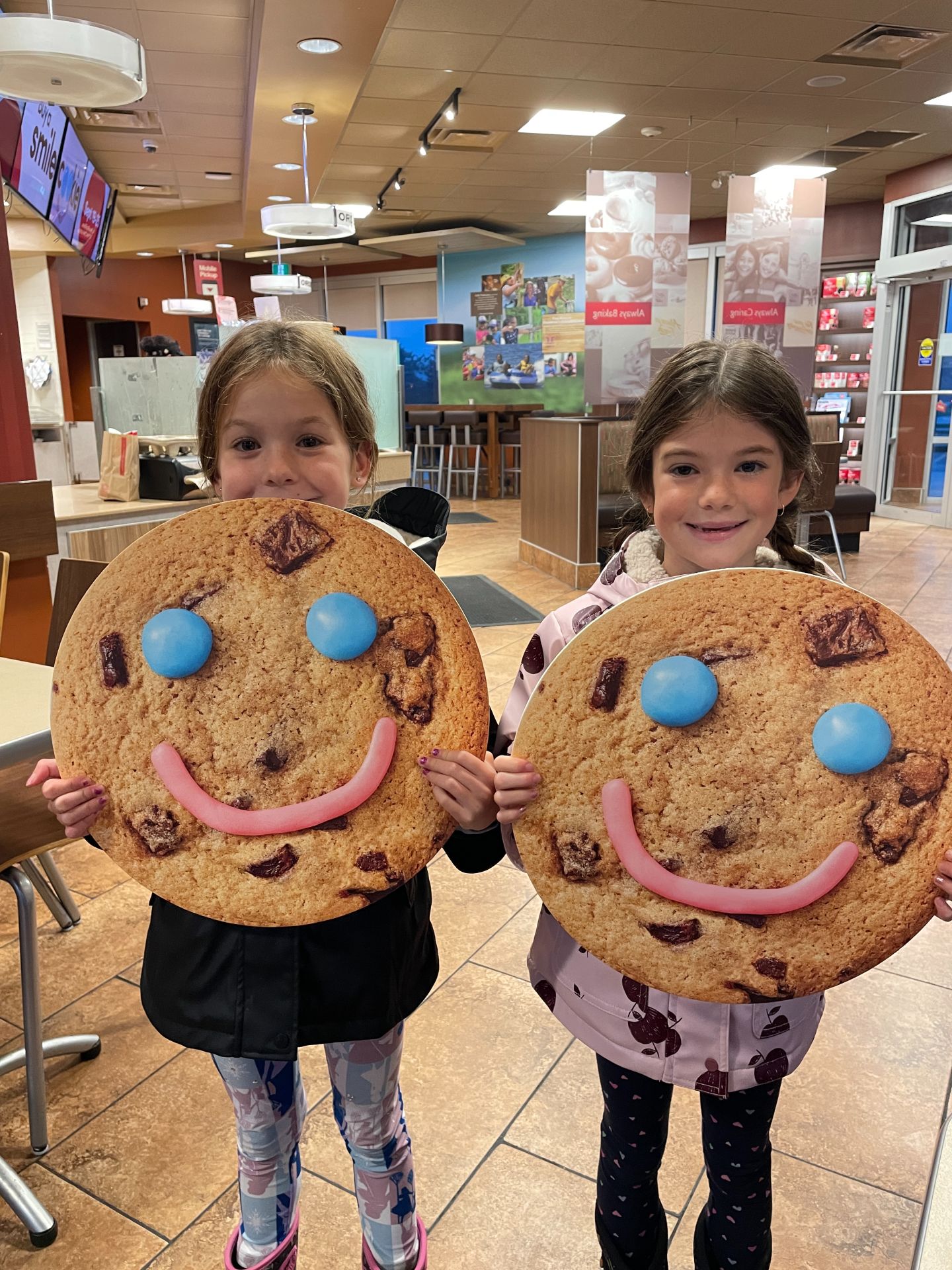 Cayden and Callie holding cookie signs